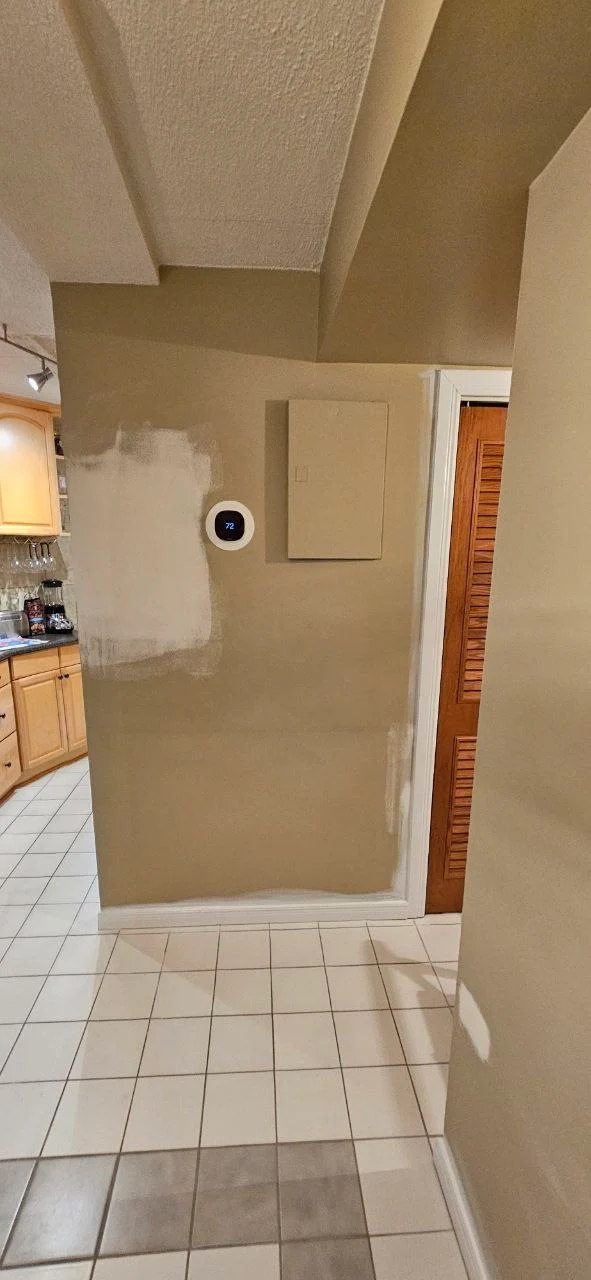 Drywall patch being applied and sanded — Windsor