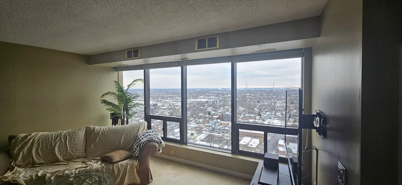 Same high-rise condo after full repaint — bulkhead and sill repaired, smooth even finish, Windsor ON